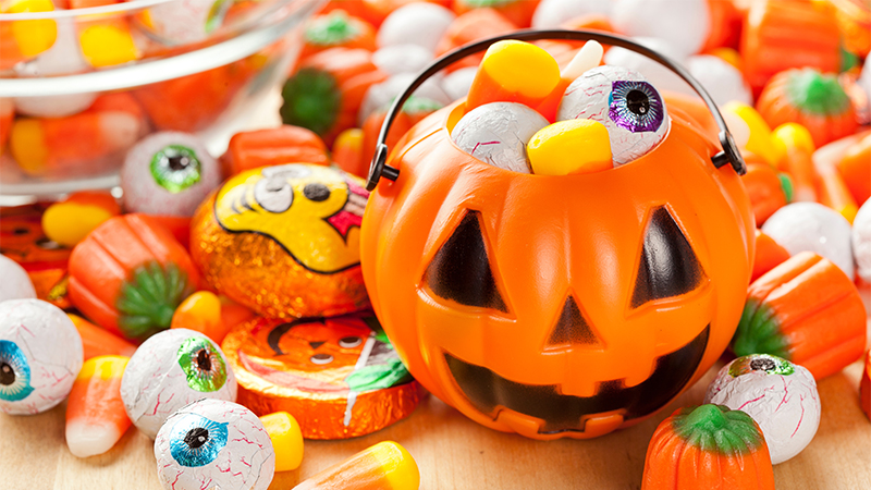 Halloween candy including chocolate, candy corn, and wrapped treats unsafe for pets.